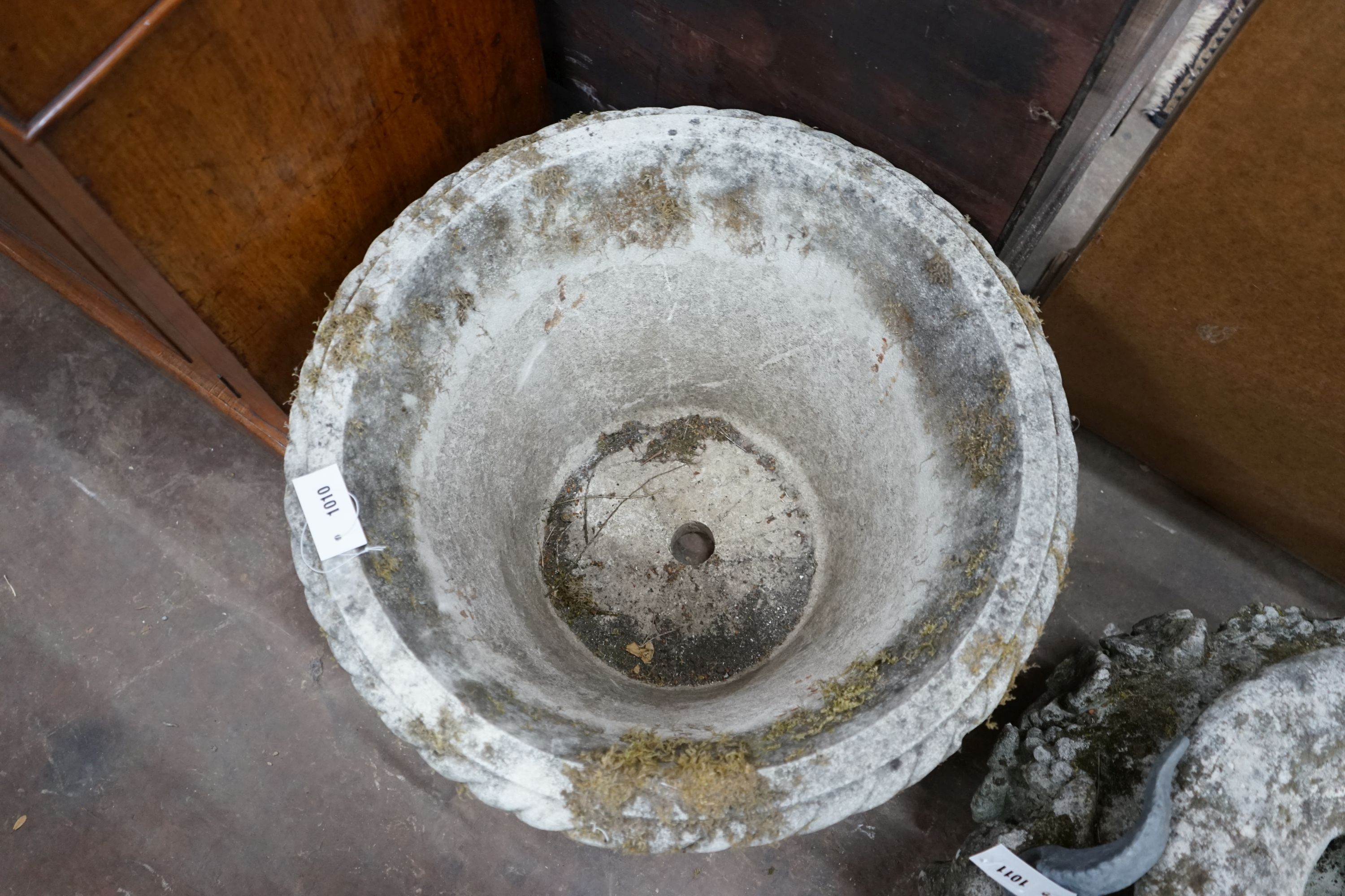 A large circular reconstituted stone garden planter, diameter 62cm, height 40cm